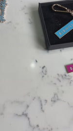 Load and play video in Gallery viewer, New Bismillah Gold Plated Hard Enamel Black Keyring by Safar London
