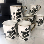 Load image into Gallery viewer, SECONDS Calligraphy Mug with gold handle and rim by Safar London
