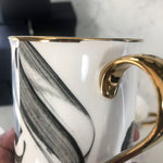 Load image into Gallery viewer, SECONDS Calligraphy Mug with gold handle and rim by Safar London
