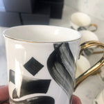 Load image into Gallery viewer, SECONDS Calligraphy Mug with gold handle and rim by Safar London
